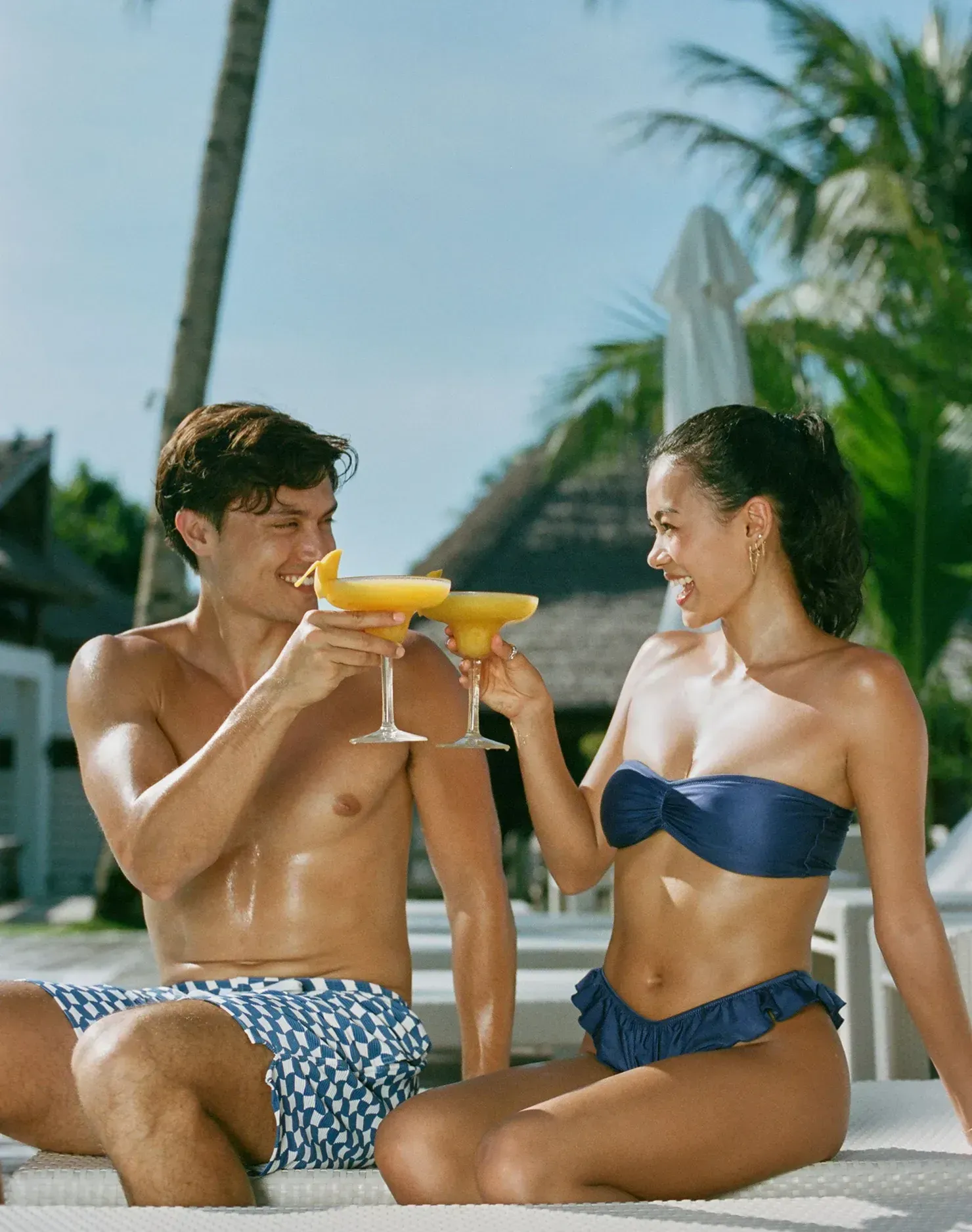 On Kelly (left) : Men’s Swim Shorts / Corfu Blue, On Ashley (right) : Nadia Top and Elsie Bottoms / Jazzy Blues Gloss